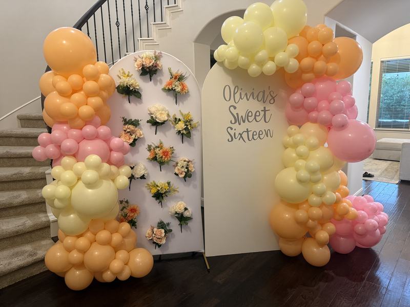 Sweet sixteen arch backdrop with a peach, pink and lemon garland