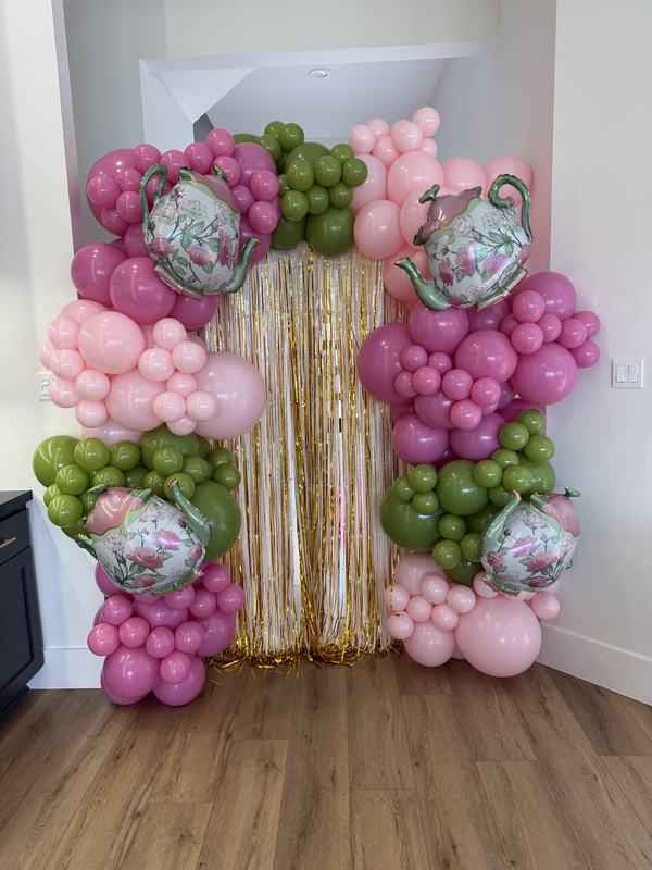 Garden tea party arch in pink and green with teapot foil balloons